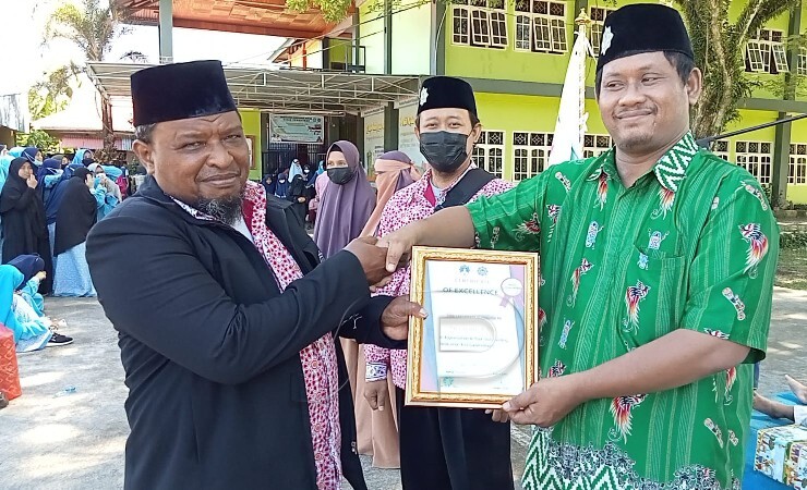 PENYERAHAN | Penyerahan penghargaan kepada salah satu guru di Yayasan Hidayatullah Timika. (Foto: Ist/Seputarpapua)