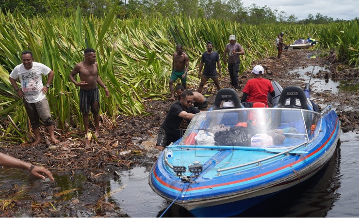 Pj Bupati Mappi Michael Gomar bersama rombongan berjibaku harus mendorong speedboat saat melintasi Sungai Weldeman. (Foto: Ist)