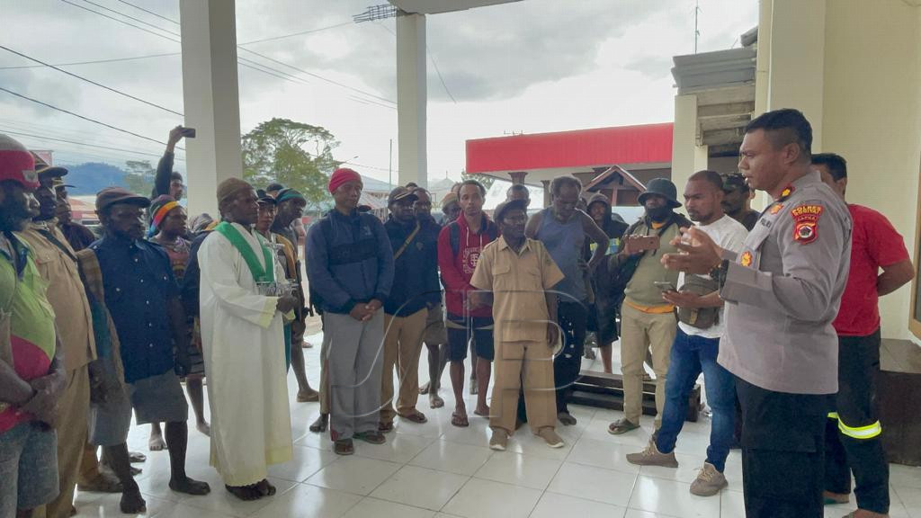 Pastor Martinus Iyai bersama dengan masyarakat setempat mengantar tiga warga yang sebelumnya dilaporkan hilang usai kerusuhan Dogiyai ke Mapolres Dogiyai, Kamis (17/11/2022). (Foto: Humas Polda Papua)