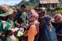 Para prajurit TNI Satgas Pamtas Yonif 527/BY saat melakukan pembagian bibit tanaman kebun di Paniai. (Foto: Dian Mustika)